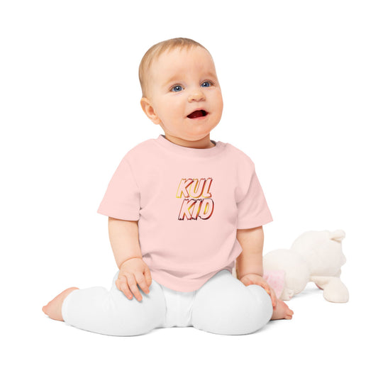 Baby iført Åpne Flammer-t-skjorte i rosa variant mot lys bakgrunn.